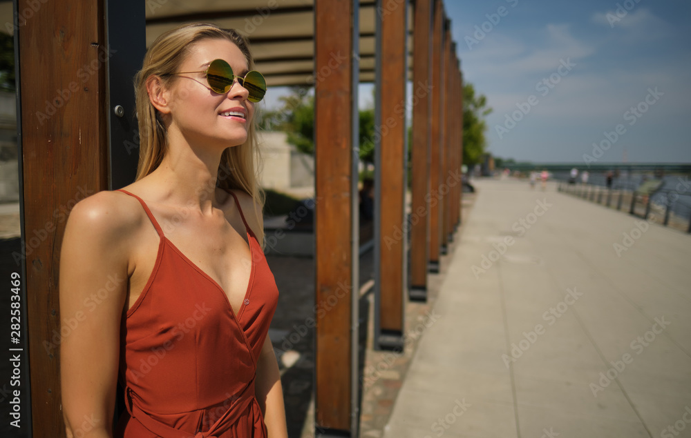 gorgeous beautiful woman in long red dress and hat walking. Portrait of happy girl in the morning outdoors gorgeous beautiful woman in long red dress and hat walking. Portrait of happy girl in the morning outdoors