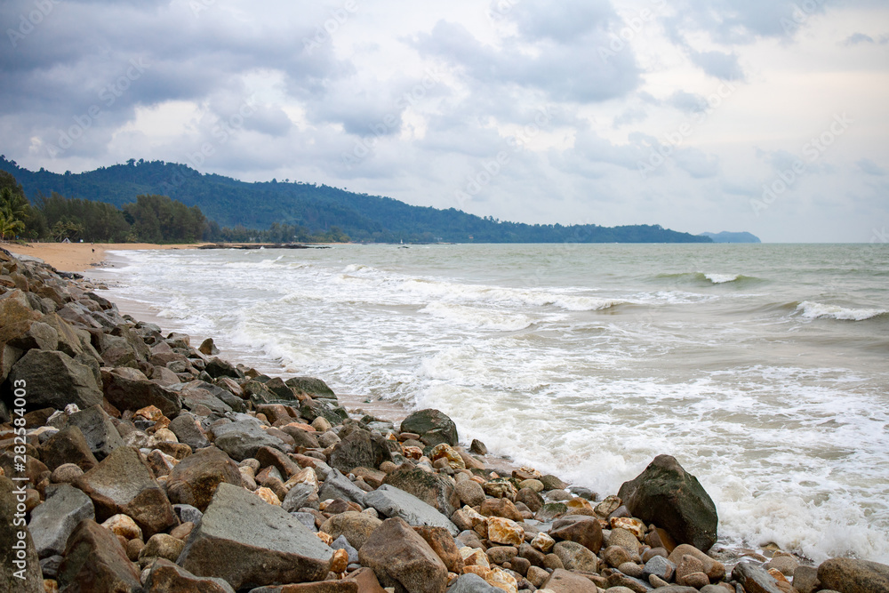 Powerful wave from sea with Rock on the beach before raining storm in Phuket province of Thailand. 