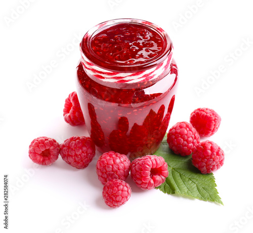 Jar of tasty raspberry jam on white background