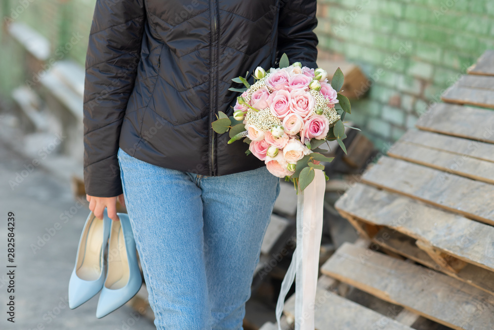 sad girl sits on a bench and holds a wedding bouquet. girl crying. broken love. sad girl sits on a bench and holds a wedding bouquet. girl crying. broken love.