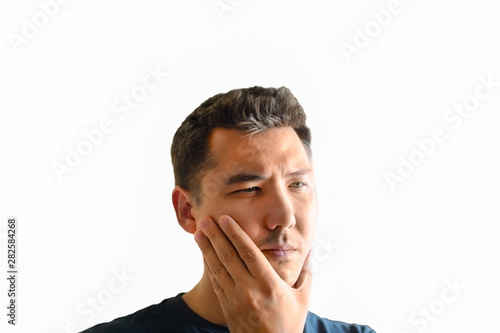 Man holds his chin with his right hand