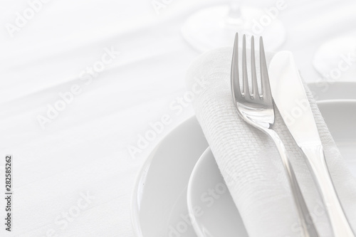 Close up of silverware fork and knife with napkin on the plate. Copy space. Restaurant dinning concept.