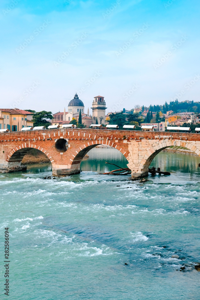 Roman arch bridge over Adige River in Verona. Historical center of European city. Romantic sightseeng trip to Italy