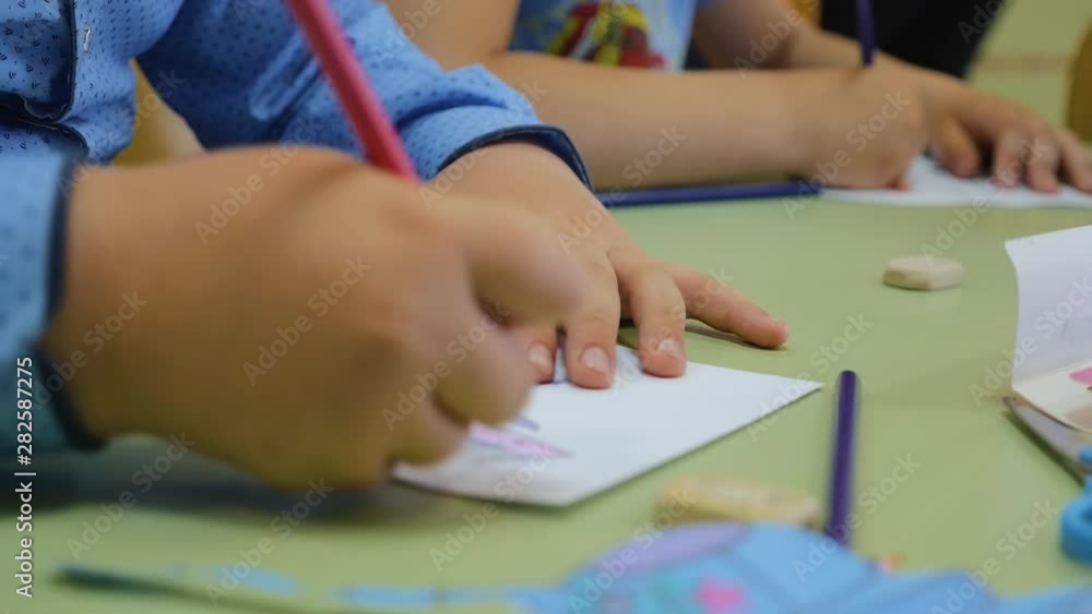 Children in kindergarten make drawings. Hands of children close-up. Children's creativity. Teamwork. Children in kindergarten make drawings. Hands of children close-up. Children's creativity. Teamwork.