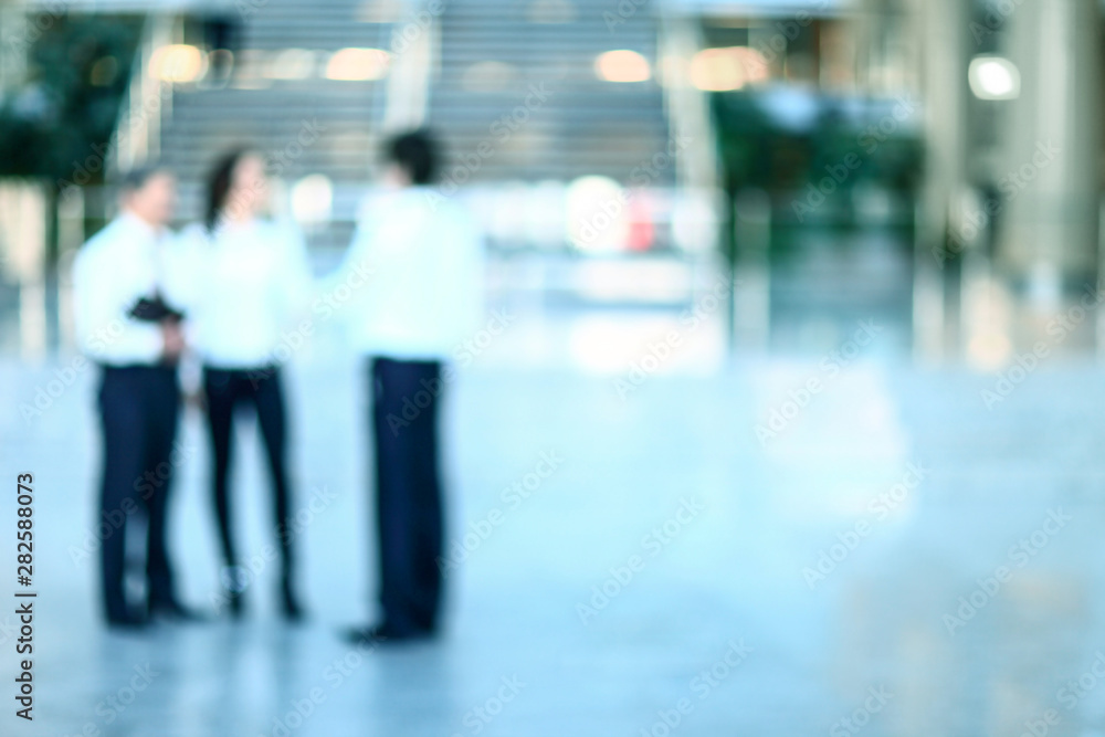 Blurred background : employees work in the lobby, spacious offic