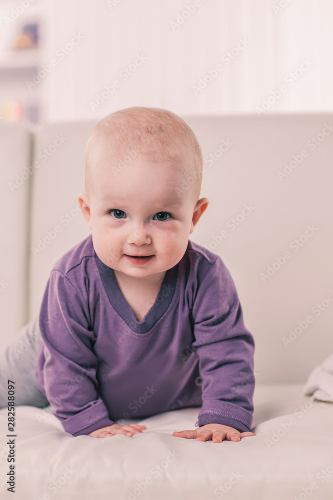 portrait of a happy one year old baby girl on a background of bright children's room portrait of a happy one year old baby girl on a background of bright children's room