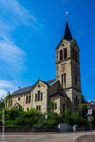 Germany  Historical church building in kaisersbach near welzheim decorated by green trees under blue sky in summer