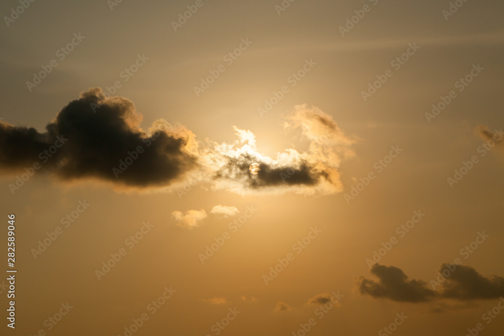 Fototapeta premium sun at sunset obscured by clouds at Thailand.