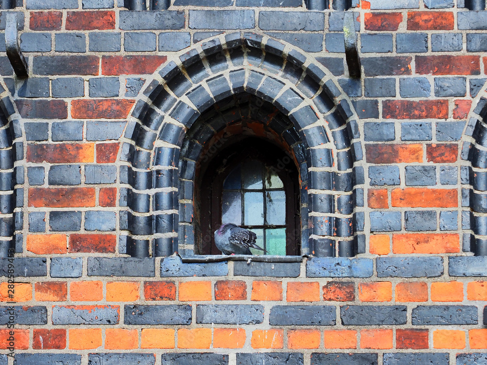 Details of Holsten Gate in Lubeck, Germany. Old town, antique brickwork, windows and decoration Details of Holsten Gate in Lubeck, Germany. Old town, antique brickwork, windows and decoration
