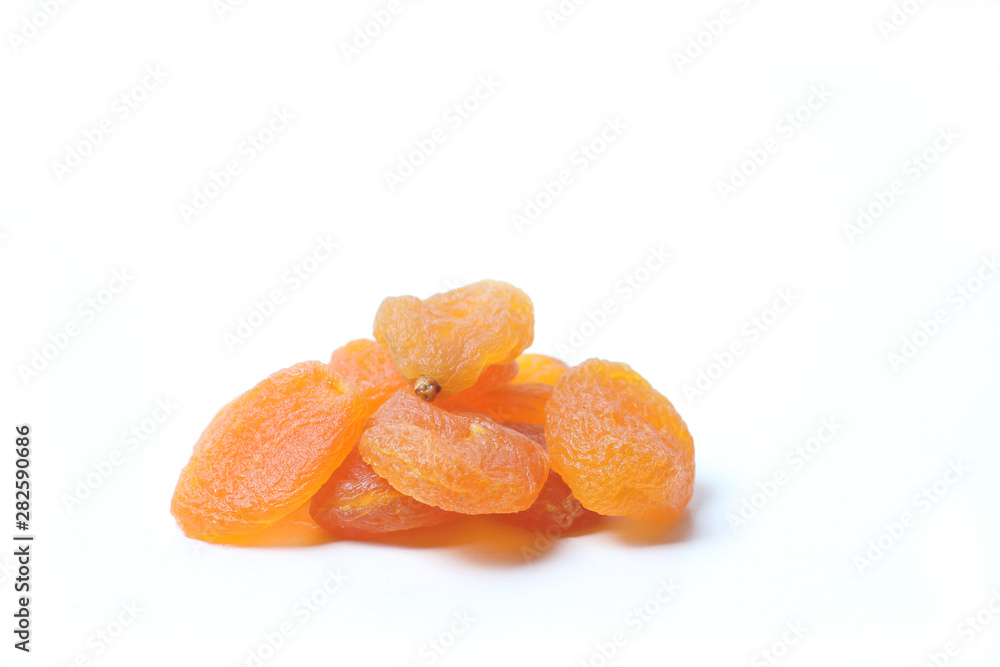 A pile of dried apricots isolated on white background A pile of dried apricots isolated on white background