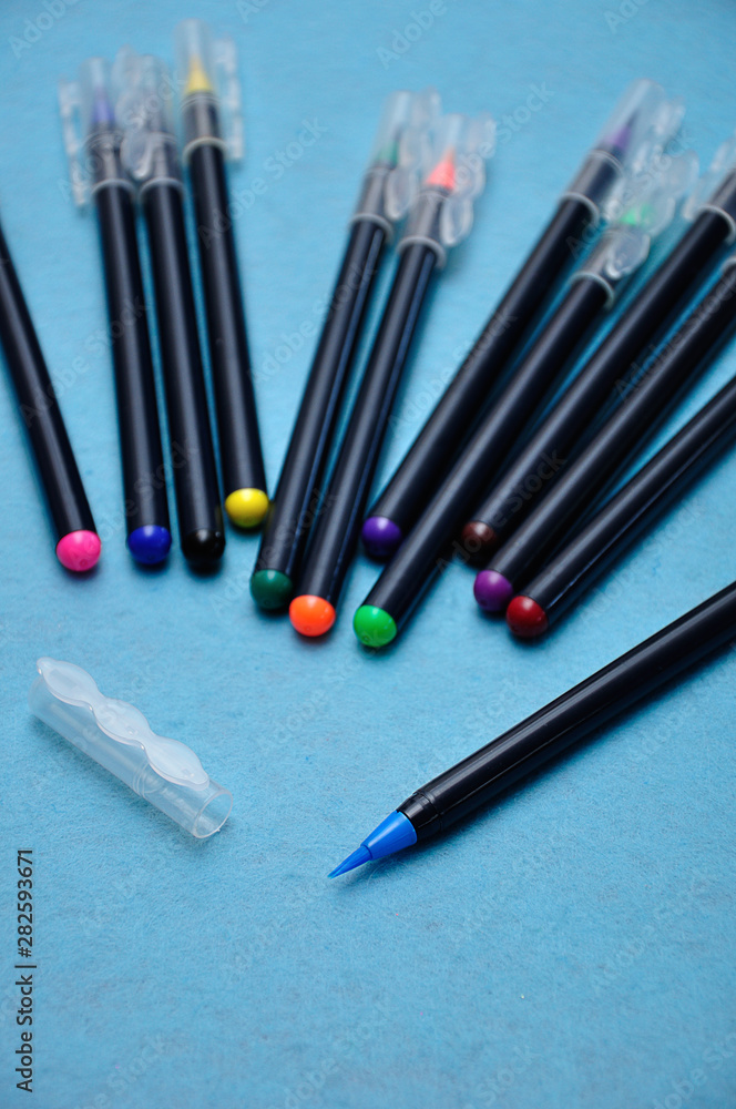 A blue color pen with the rest out of focus on a blue background A blue color pen with the rest out of focus on a blue background