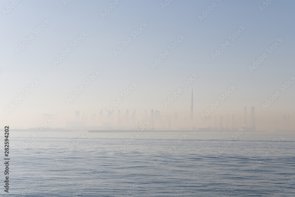 Skyline of Dubai at sunrise seen from the sea