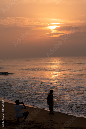 Silhouette People at Puri Beach at the time of Sunrise. © ABIR