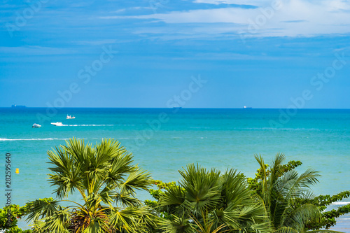 Aerial view of sea ocean view around with coconut palm tree on blue sky