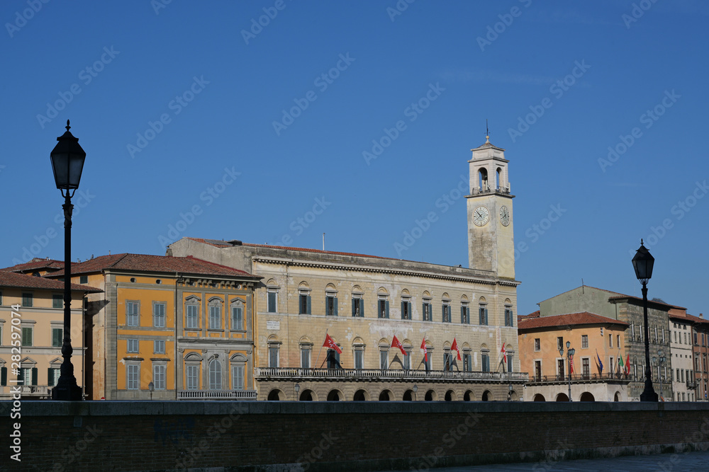 Palazzo Pretorio in Pisa, the seat of the municipal library on the Lungarno Galilei, near the bridge Ponte di Mezzo on the river Arno, Italy
