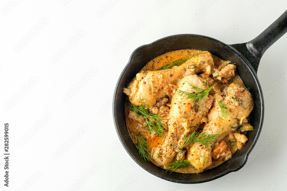 Spicy chicken in a sauce in a frying pan. top view from above