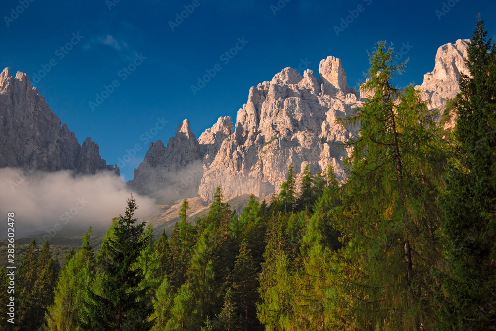 The first rays of sun at dawn, illuminate the peaks of the Friulian Dolomites, near the Rifugio Giaff, in Friuli, Italy.