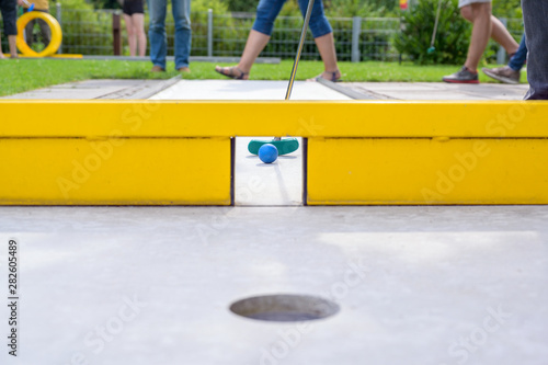 Mini golf course with a yellow obstacle gate photo