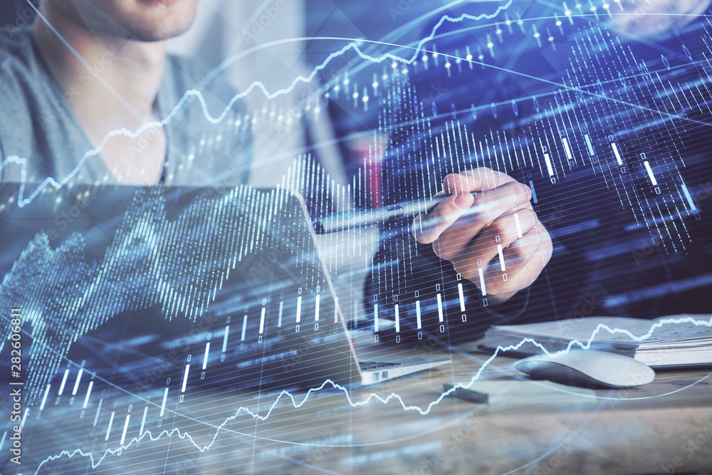 Forex graph with businessman typing on computer in office on background. Concept of analysis. Double exposure. Forex graph with businessman typing on computer in office on background. Concept of analysis. Double exposure.
