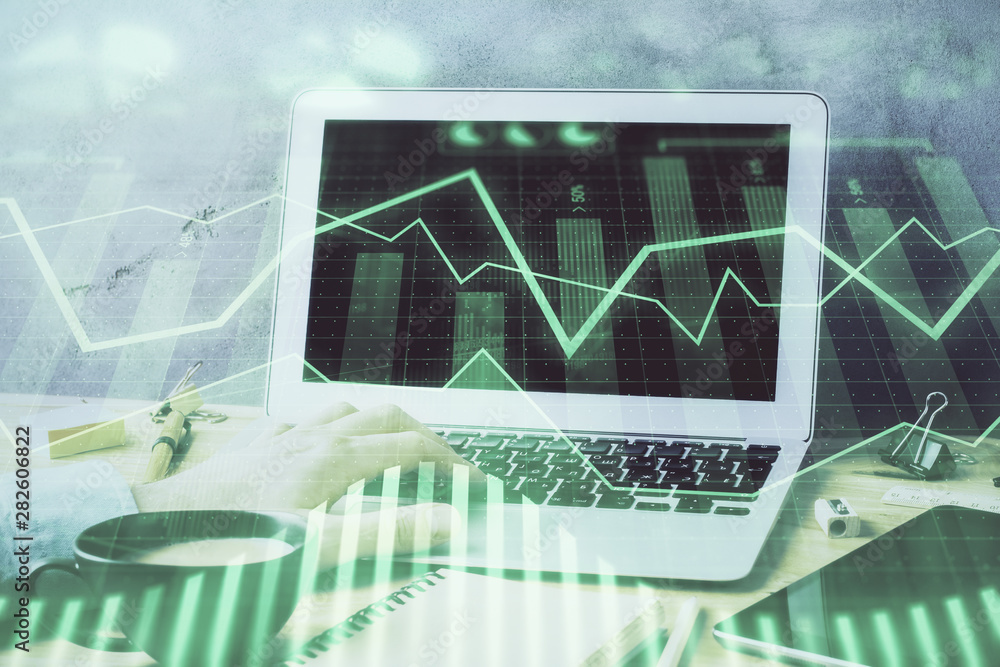 Forex graph with businessman working on computer in office on background. Concept of hardworking. Double exposure. Forex graph with businessman working on computer in office on background. Concept of hardworking. Double exposure.