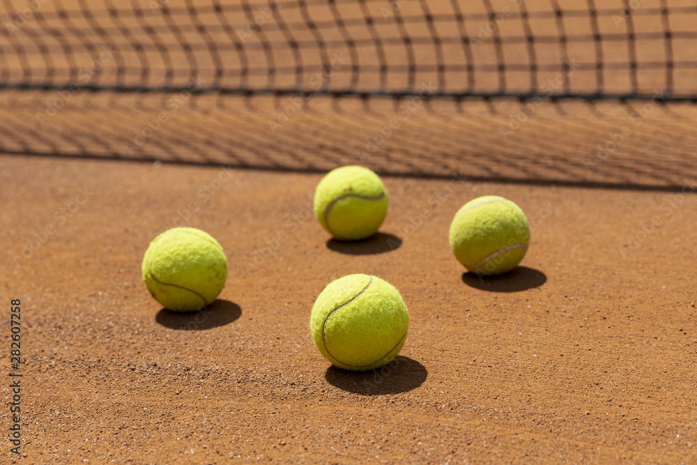 Close-up tennis balls on court ground
