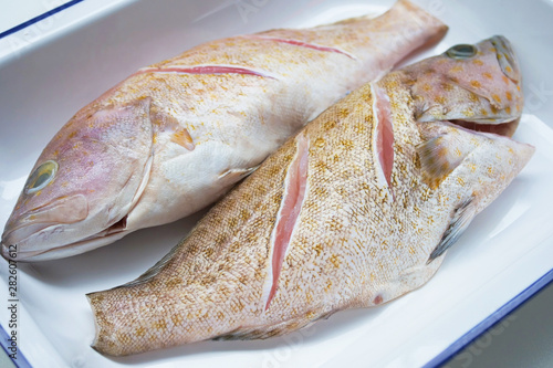 Fresh grouper on a plate ready to cook