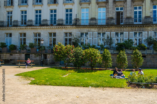 People rest on the lawn on Le Cours Cambronne square in Nantes, France