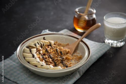 Tasty and healthy breakfast: fruits, corn flakes, milk and honey. © makistock