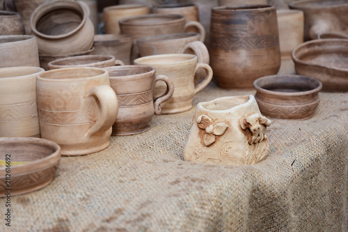 Traditional Ceramic Jugs of Handmade Ceramic Pottery in a Roadside Market with Ceramic Clay Caps  Outdoors. © bildlove