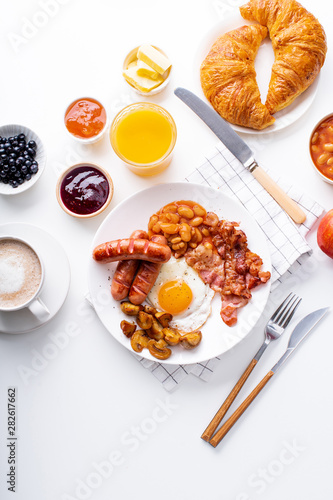 Classical english breakfast with fried bacon, mushrooms and eggs. Served with oange juice and black coffee.