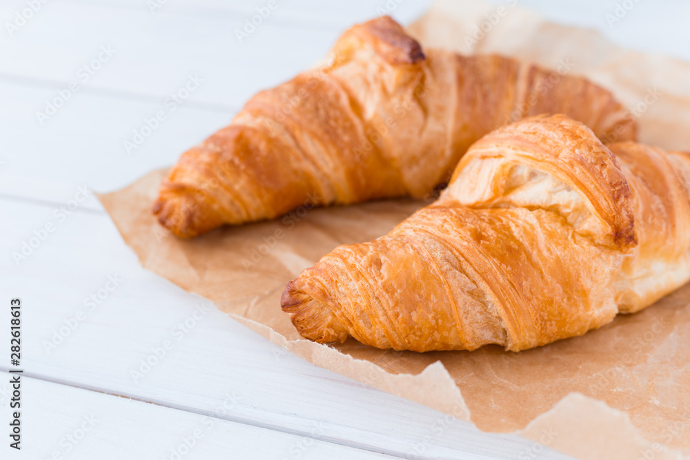 Croissants on a white wooden board. View from above. Top view.