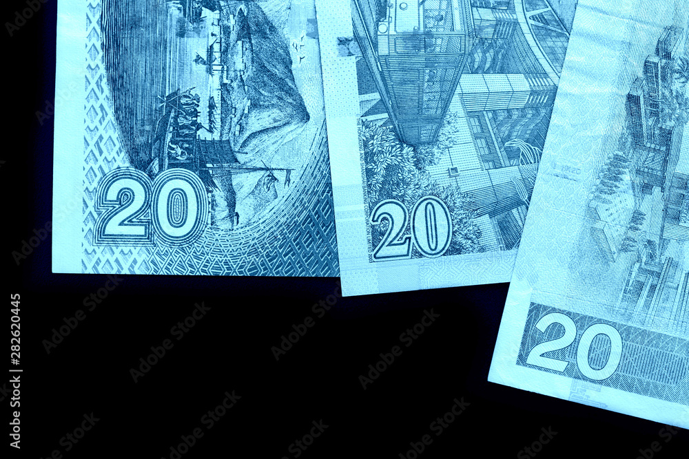 Fototapeta premium Different bills in twenty Hong Kong dollars close up. Money background blue color toned
