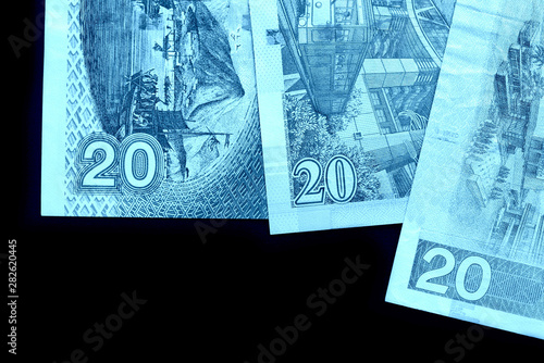 Different bills in twenty Hong Kong dollars close up. Money background blue color toned