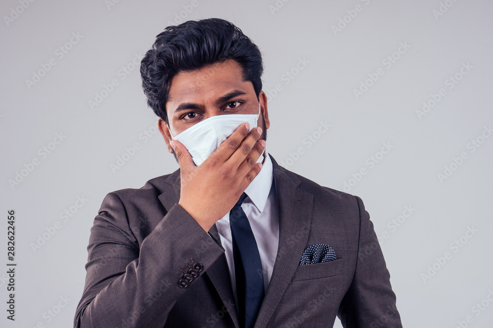 young indian business man protect his healthy with medical mask at work in studio on white background