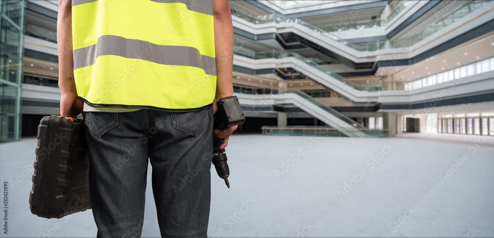 Fototapeta premium Construction Worker in front of construction site