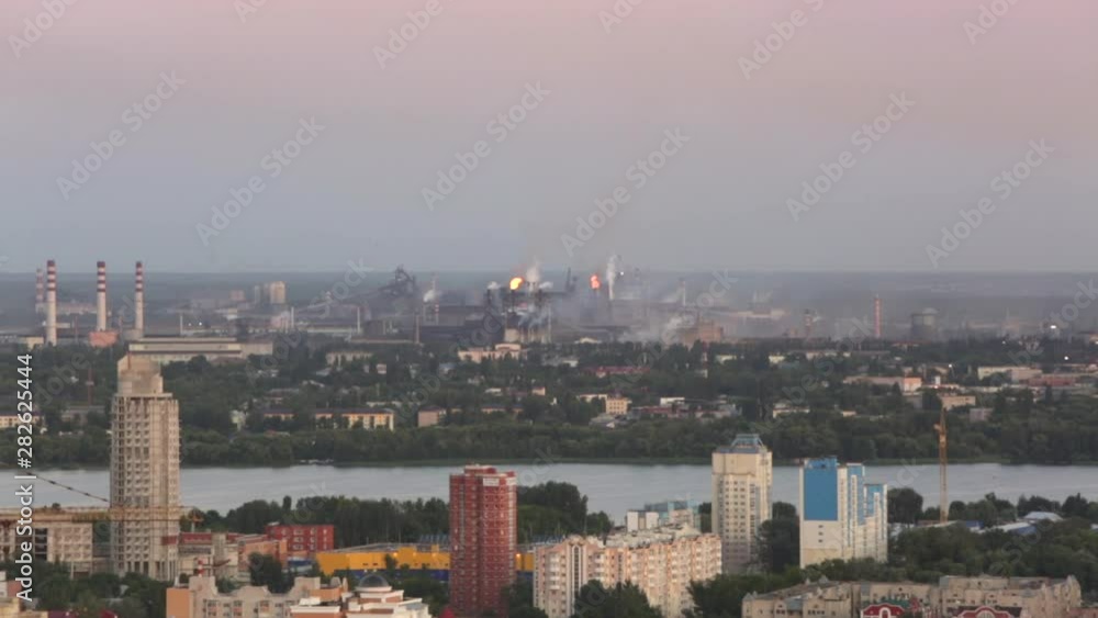 City on a background of a factory with burning pipes. Smoke from the pipes. environmental pollution. Pollution of the atmosphere and environment. Bad ecology and health problems in the population City on a background of a factory with burning pipes. Smoke from the pipes. environmental pollution. Pollution of the atmosphere and environment. Bad ecology and health problems in the population