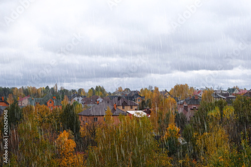 Autumn on outskirts of city. Bright blue sky with thick clouds. September, October, November. Rainy day.