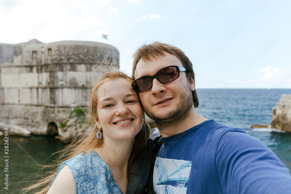 Travelling young couple take the selfie shot, smiling and happy in Dubrovnik, Croatia Travelling young couple take the selfie shot, smiling and happy in Dubrovnik, Croatia
