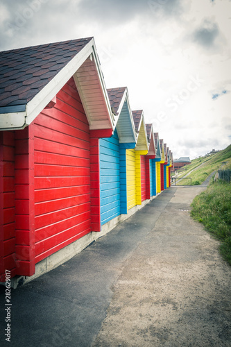 Bright, colorful beach huts in Whitby, England © JulietPhotography