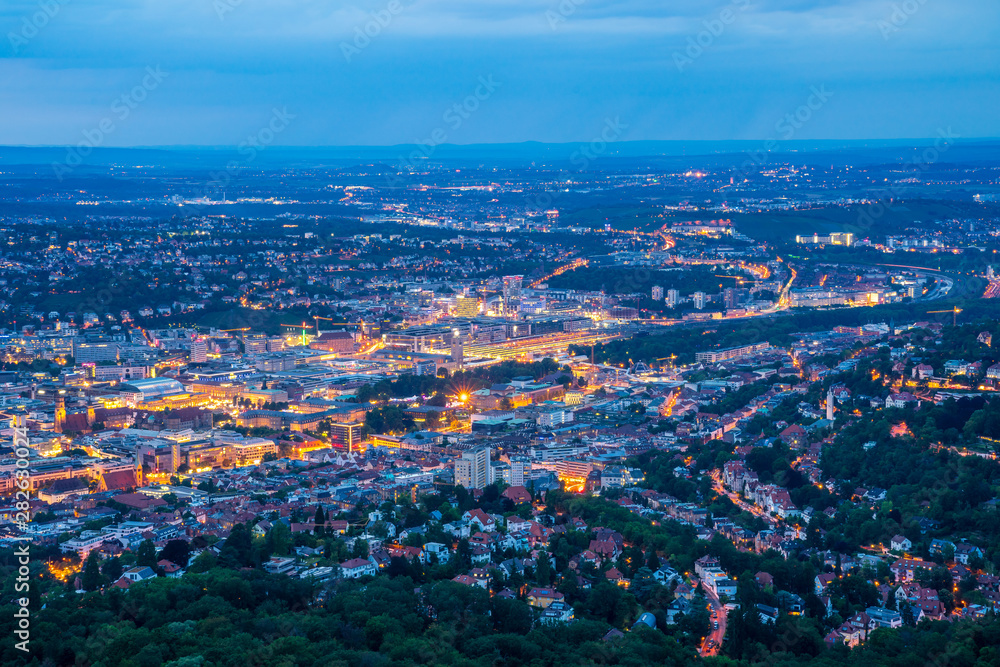 Obraz premium Germany, Magical illuminated lights of stuttgart city houses, buildings, streets and cranes by night from above aerial perspective