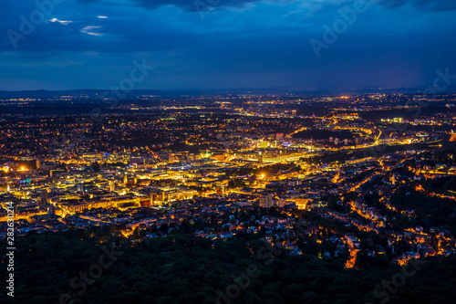 Germany, Orange night lights illuminating stuttgart city skyline from above aerial view in summer in magical atmosphere