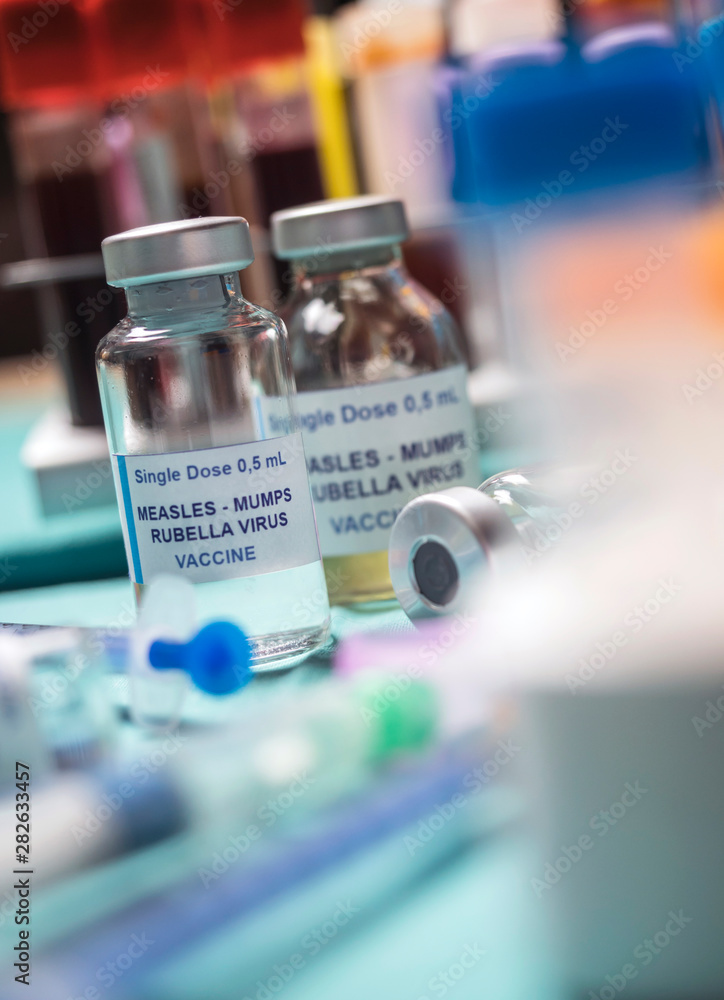 Different vials of triple viral vaccine of measles, rubella and mumps, known as MMR, conceptual image