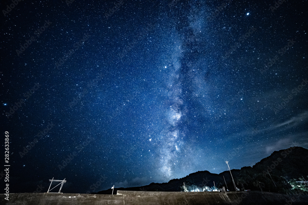 Milky way and stars with beach beds at night