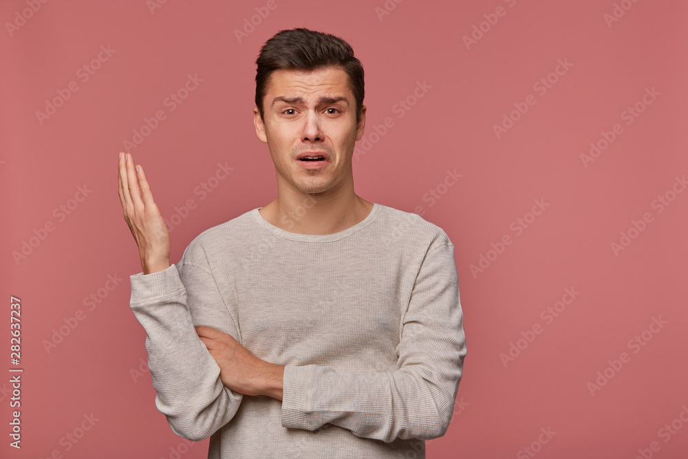 Portrait of young indigant guy wears in blank long sleeve, looks at the camera with surprised expression, looks shocked, isolated over pink background. Portrait of young indigant guy wears in blank long sleeve, looks at the camera with surprised expression, looks shocked, isolated over pink background.