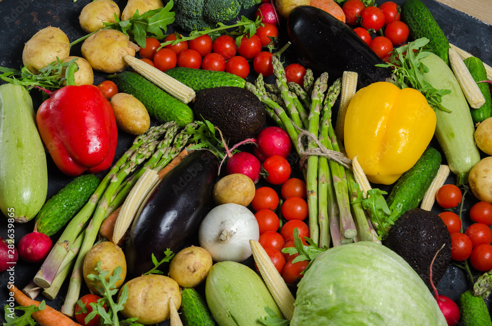 top view portrait of Assortment of fresh raw vegetables on black wooden background. top view portrait of Assortment of fresh raw vegetables on black wooden background.