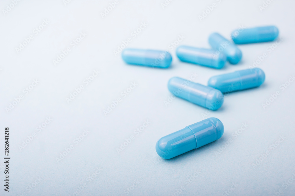 Blue pills macro on blue background Blue pills macro on blue background