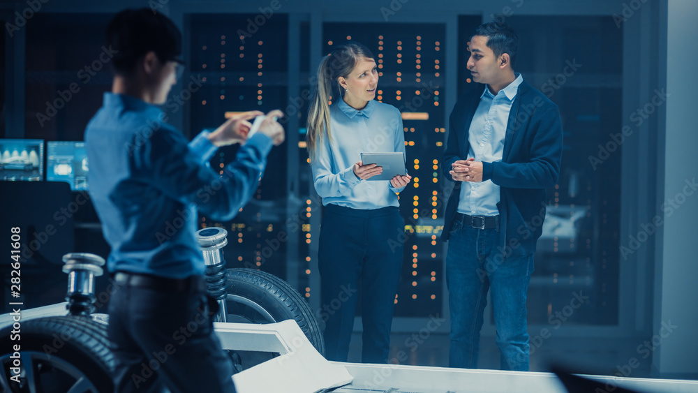 Automotive Design Engineer and Scientist with Tablet Discuss the