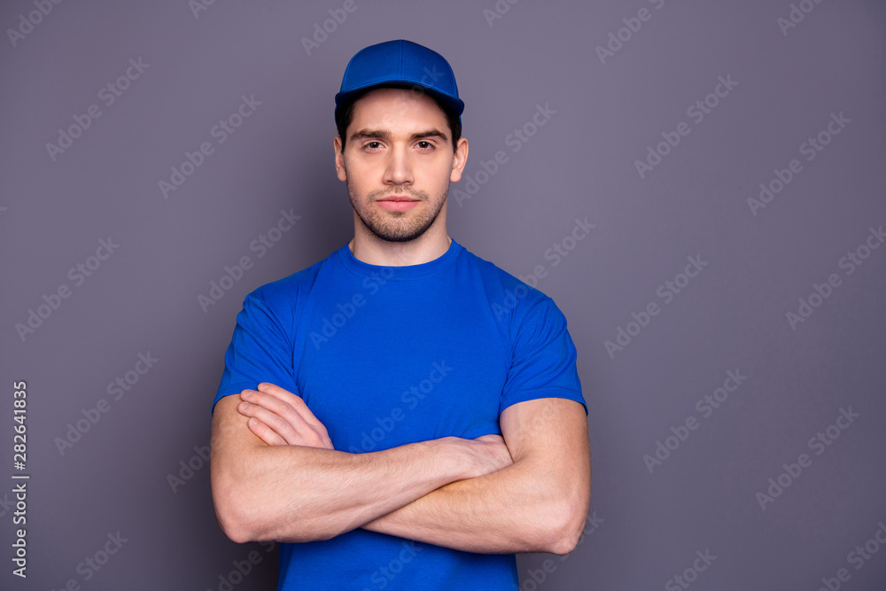 Close up photo express specialist he him his delivery boy strong arms crossed not smiling self-confident person wait order offer customer wear blue t-shirt cap corporate suit isolated grey background Close up photo express specialist he him his delivery boy strong arms crossed not smiling self-confident person wait order offer customer wear blue t-shirt cap corporate suit isolated grey background