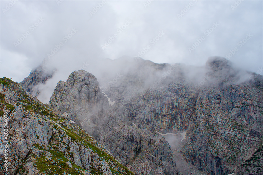 Fog on rocky mountain peaks dramatical hike