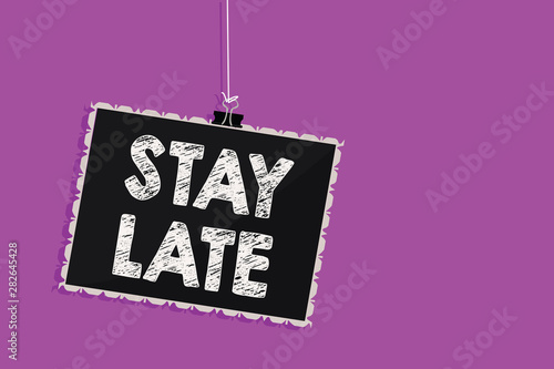 Text sign showing Stay Late. Conceptual photo A routine in which a person goes to somewhere out of time Hanging blackboard message communication information sign purple background photo